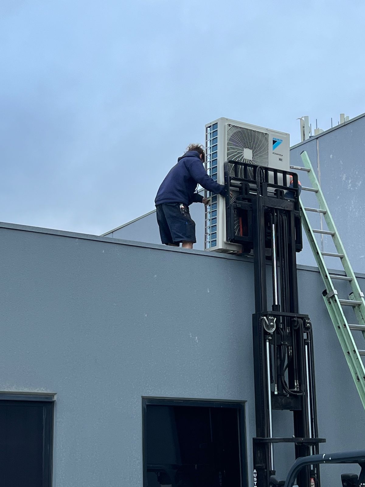 Technician carrying out heating and air conditioning work in Melbourne