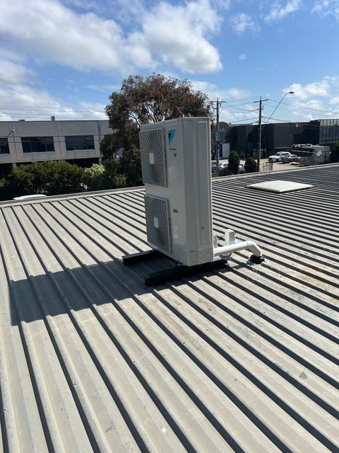 Daikin condenser on an industrial metal roof