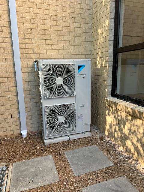 Daikin ducted outdoor unit on a concrete pad